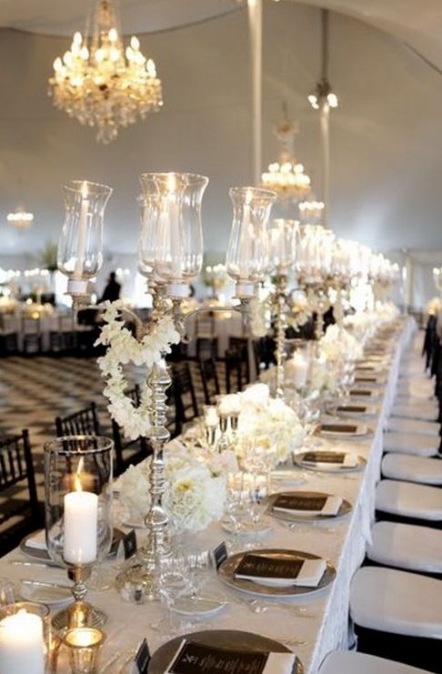a white and silver tablescape with black chargers and menus to create a contrasting look