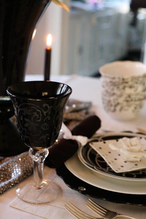 a whimsy tablescape with polka dots and botanical patterns all done in black and white for more chic