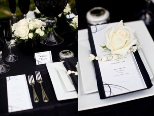 a modern black and white tablescape with a neutral floral centerpiece, beads, white roses and a black and white menu