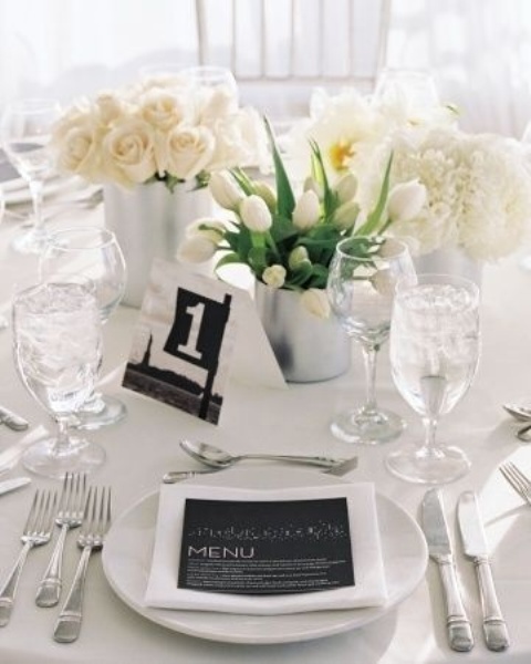 a neutral tablescape with black touches - a black table number and a black menu for more drama