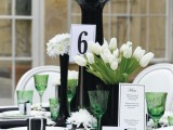 a chic black and white tablescappe with green touches – glasses and tulip leaves