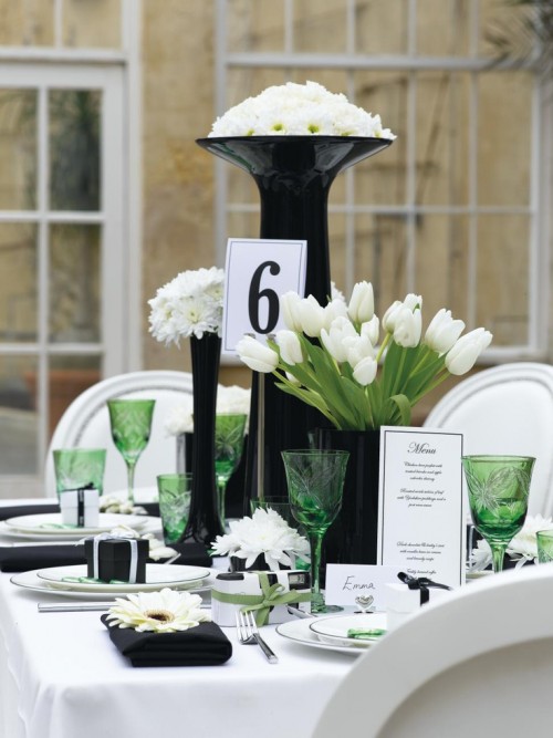 a chic black and white tablescappe with green touches - glasses and tulip leaves