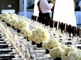 printed napkins and a table runner, neutral floral centerpieces and white candles and clear glasses