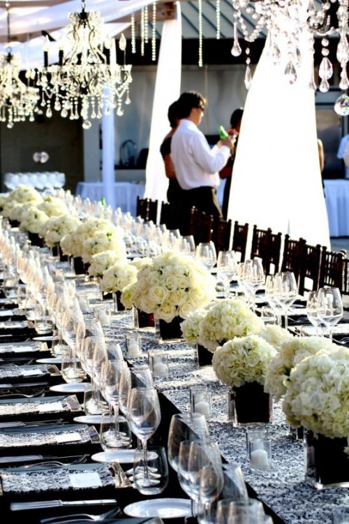printed napkins and a table runner, neutral floral centerpieces and white candles and clear glasses