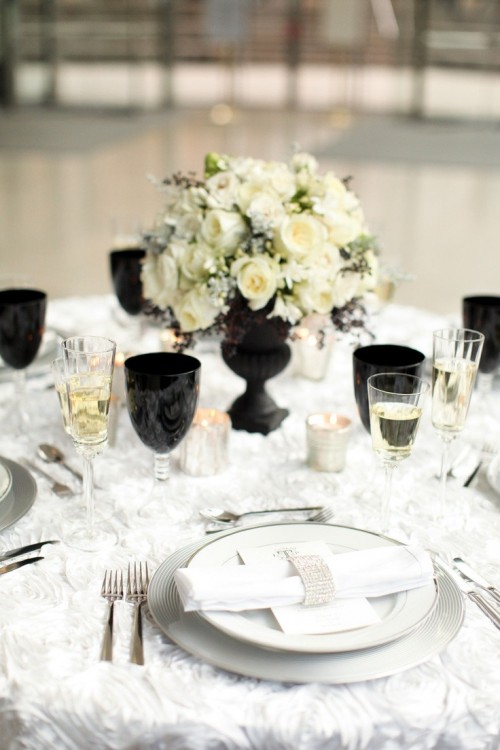 black glasses and a vase make the neutral table setting chic, bold and modern