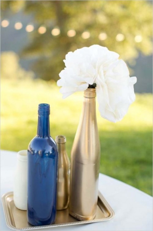 navy and gold bottle vases with white blooms for decor