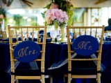 gold chairs with navy and gold signage for an elegant wedding