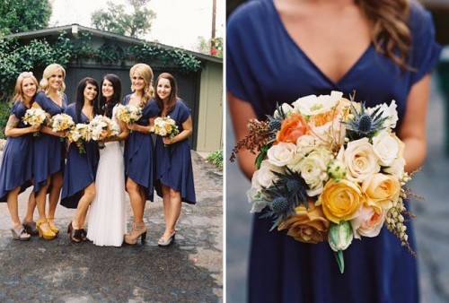 bridesmaids wearing high low navy knee dresses and holding yellow and gold bouquets