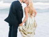 the groom wearing a navy suit, the bride wearing a gold sequin strapless gown