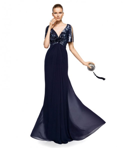 a midnight blue A-line mother of the bride dress with an embellished bodice, cutout sleeves and a pleated and flowy skirt with a train is very formal and elegant