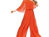 a flowy orange suit with a one shoulder top with a single sleeve and wideleg pants plus gold shoes and accessories for a refined look