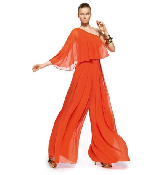 a flowy orange suit with a one shoulder top with a single sleeve and wideleg pants plus gold shoes and accessories for a refined look