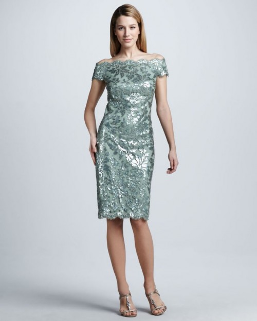 a shiny green off the shoulder botanical fitting knee dress is a stylish and beautiful option for a mother of the bride