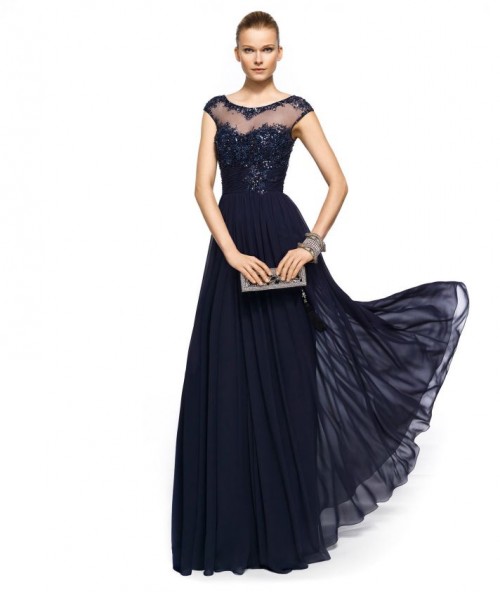 a refined midnight blue mother of the bride dress with an embellished bodice, a pelated skirt and an illusion neckline plus statement accessories