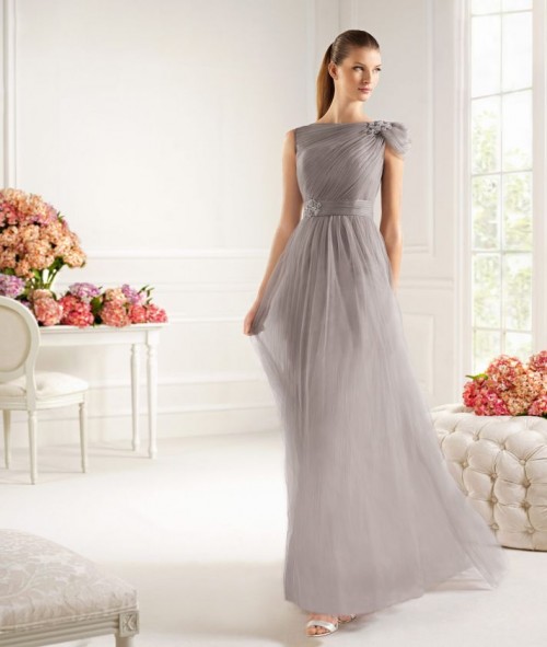 an airy grey draped A-line maxi dress with a single cap sleeve and silver shoes for a very elegant a chic mother of the bride look