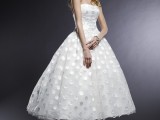 a strapless a-line tea length wedding dress with silver polka dots and white ankle strap shoes for a beautiful vintage look