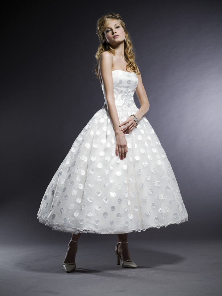 A strapless a line tea length wedding dress with silver polka dots and white ankle strap shoes for a beautiful vintage look