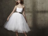 a strapless a-line wedding dress with a plain bodice and a tulle skirt, a sash and black shoes for a modern take on a traditional look