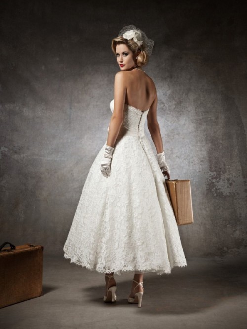 a lace sstrapless A-line tea length wedding dress, gloves, shoes and a veil with a fabric bloom for a vintage look