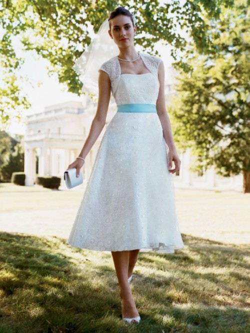 a lace strapless A-line tea length wedding dress with cap sleeves, a blue sash, pearls and peep toe wedding shoes