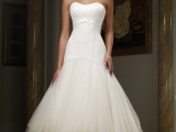 a strapless A-line tea length wedding dress witha  draped bodice, a pleated tulle skirt, silver shoes and elegant accessories