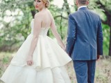a strapless A-line tea length wedding dress with a tiered skirt and a lace bodice, lace flat shoes for an elegant look