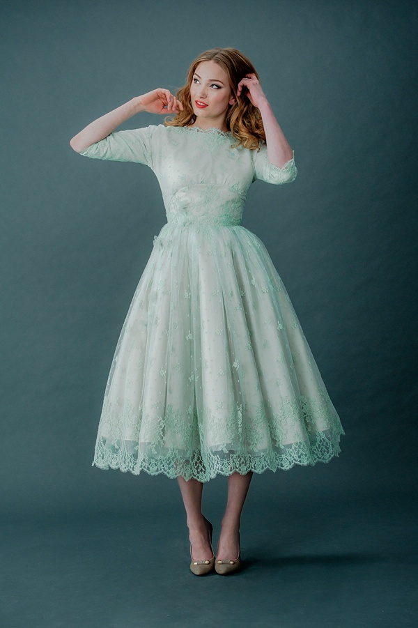 A mint green tea length lace A line wedding dress with short sleeves, a high neckline and grey vintage shoes just wows