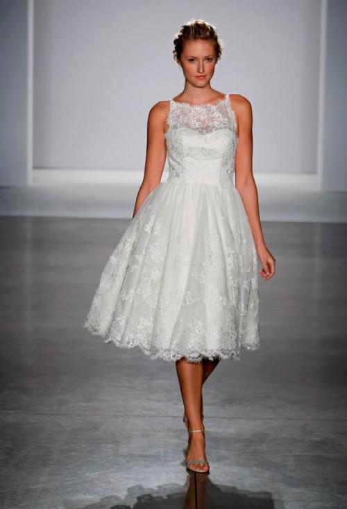 a sleeveless lace tea length wedding dress with an illusion neckline and a pleated skirt is a very chic and timeless idea