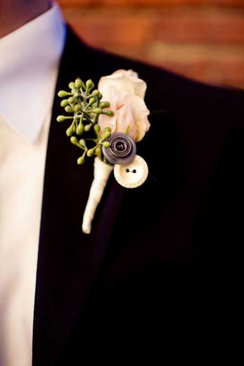 a refined vintage wedding boutonniere of a blush rose, some seeded eucalyptus and buttons is a lovely and delicate accessory for a groom