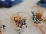 vintage boutonnieres of dried blooms, berries and twine wraps and bows are gerat for a vintage rustic groom’s look