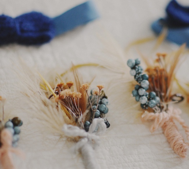 vintage boutonnieres of dried blooms, berries and twine wraps and bows are gerat for a vintage rustic groom's look