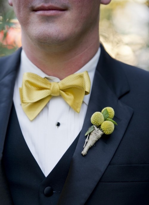 a colorful vintage wedding boutonniere of billy balls and a twine wrap is a stylish idea to add color, it echoes with the bow tie