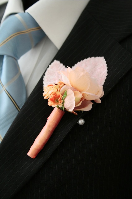 a paper and fabric flower boutonniere with leaves and a ribbon wrap is a simple solution that can be DIYed anytime