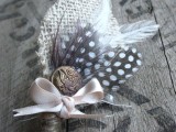 a vintage wedding boutonniere with burlap leaves, feathers, a vintage button, a ribbon bow is a lovely idea for a boho groom