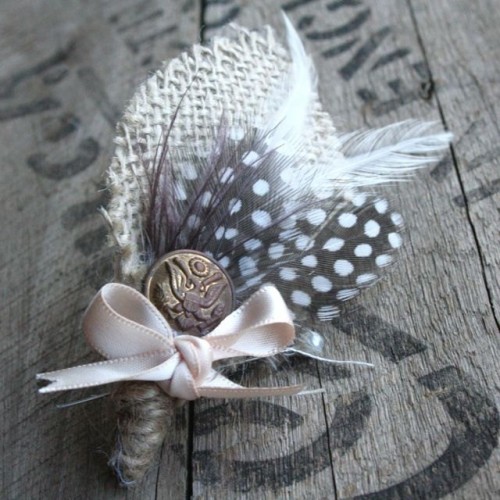 a vintage wedding boutonniere with burlap leaves, feathers, a vintage button, a ribbon bow is a lovely idea for a boho groom