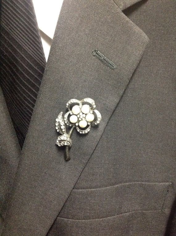 a vintage bejeweled pin shaped as a flower can be rocked as a chic and fun wedding boutonniere