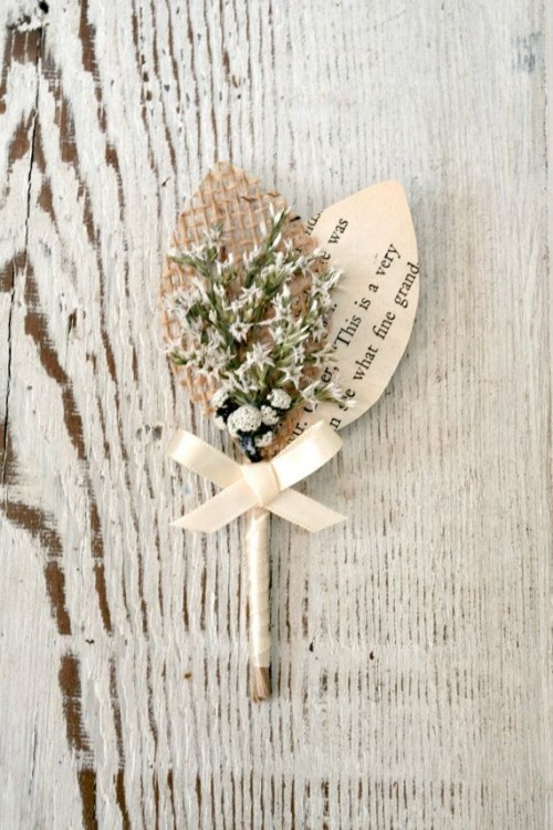 a vintage rustic wedding boutonniere of blooms, a paper and a burlap leaf and a ribbon bow is a lovely idea for a vintage wedding