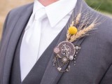 a catchy vintage wedding boutonniere of a vintage clock face, wheels, a vintage key, some dried blooms and grass is amazing