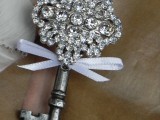 a gorgeous jeweled wedding boutonniere of a vintage key with rhinestones and a ribbon bow is amazing for a vintage wedding