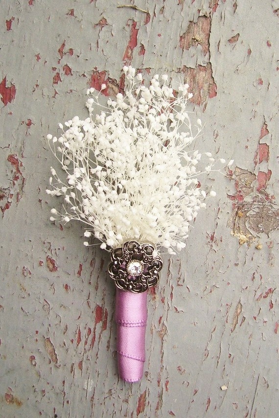 a beautiful vintage boutonniere of white dried blooms, a pink ribbon wrap and a tiny vintage brooch is a very chic and stylish accessory for a wedding