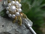 a vintage wedding boutonniere of a vintage key, pearls and chain, gold leaves is a gorgeous idea for a vintage wedding