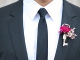 a vintage wedding boutonniere of a key, baby’s breath and a fuchsia rose is a cool idea with a touch of color