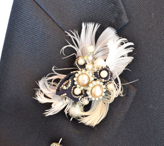 a lovely vintage wedding boutonniere of vintage brooches, feathers and a black ribbon is a lovely idea for a vintage groom's look