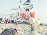 beach bridal shower decor with floats, a large float vase with blooms and branches and net covering the float