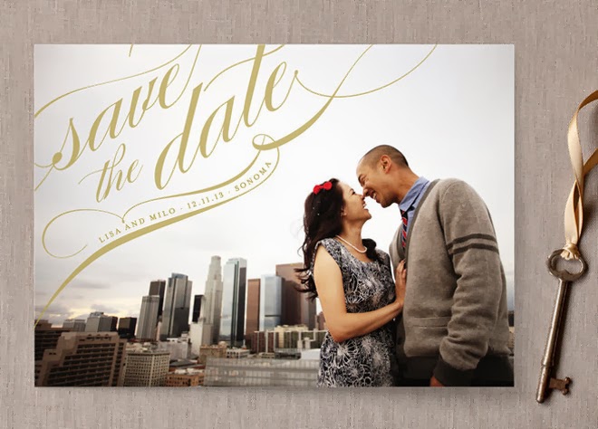 a large save the date wedding magnet styled as a card with a photo from the couple's engagement photo shoot