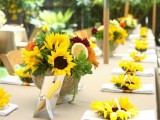 a colorful summer bridal shower table with bright blooms and citrus, neutral linens and umbrellas over the table