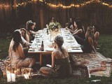 a backyard picnic bridal shower with a low table, rugs, candle lanterns and blooms is a cozy and cool idea