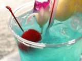 a blue signature drink, with pineapples, cherries and tropical blooms is amazing for a bright summer bridal shower