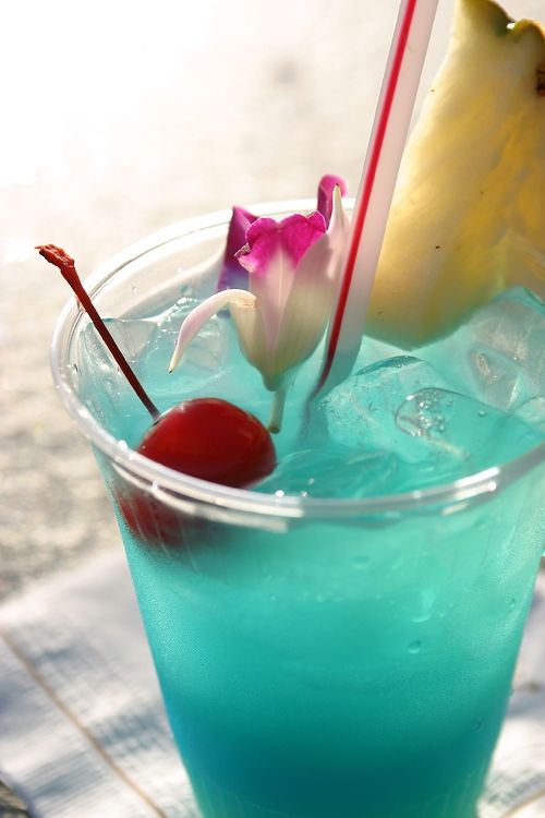 a blue signature drink, with pineapples, cherries and tropical blooms is amazing for a bright summer bridal shower