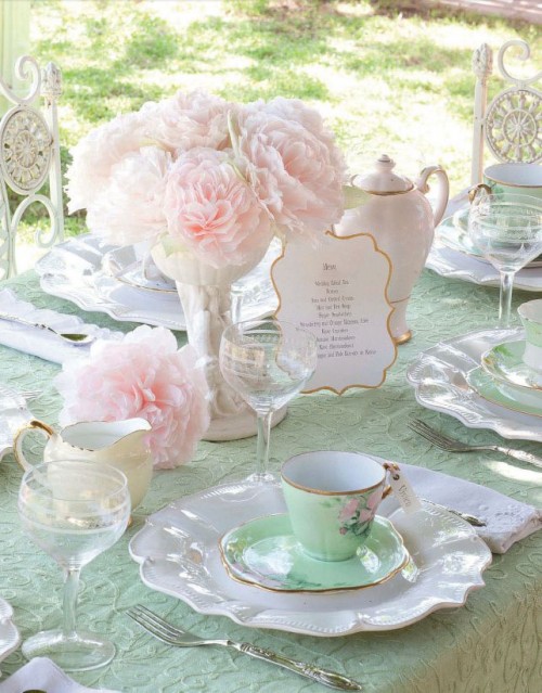 a sweet vintage tablescape for a summer bridal shower, with a mint tablecloth and napkins, with blush blooms and vintage teaware